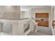 Hallway with staircase, glass railing, and built in cabinet at 7524 E Leland Cir, Mesa, AZ 85207