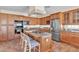 Spacious kitchen features granite countertops, wood cabinets and a large center island with cooktop at 7524 E Leland Cir, Mesa, AZ 85207