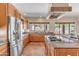 Modern kitchen with stainless steel appliances, center island, granite countertops and a view to the backyard at 7524 E Leland Cir, Mesa, AZ 85207