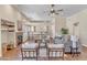 Large living room with high ceilings, ceiling fan, fireplace and French doors to outdoor space at 7524 E Leland Cir, Mesa, AZ 85207