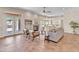 Bright living room with high ceilings, fireplace, bar area, and French doors leading to outdoor patio at 7524 E Leland Cir, Mesa, AZ 85207