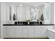 Bright bathroom features dual sinks, modern mirrors, and custom storage cabinets at 7673 E Sands Dr, Scottsdale, AZ 85255