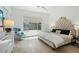 Bright bedroom showcases designer headboard, plush chair, and sleek tiled floors at 7673 E Sands Dr, Scottsdale, AZ 85255