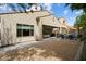 Rear view of property with covered patio, outdoor kitchen, and landscaped yard at 7673 E Sands Dr, Scottsdale, AZ 85255