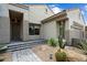 Desert landscaping with a stone paver walkway leads to the front door of this tan single-story home at 7673 E Sands Dr, Scottsdale, AZ 85255