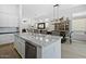 Open kitchen with white cabinetry, granite countertops, stainless steel appliances, and modern pendant lighting at 7673 E Sands Dr, Scottsdale, AZ 85255