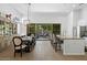 Open kitchen with a large island with seating and view of outdoor dining area through sliding glass doors at 7673 E Sands Dr, Scottsdale, AZ 85255