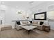 Bright living room boasts hardwood floors, a modern mirror and neutral paint colors at 7673 E Sands Dr, Scottsdale, AZ 85255