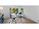 Bright office features a sleek glass desk, modern chairs, and a large garden view at 7673 E Sands Dr, Scottsdale, AZ 85255