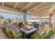 Relaxing outdoor patio with a fire pit, comfortable seating, and an elegant white pergola at 8210 E Del Cadena Dr, Scottsdale, AZ 85258
