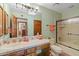 Full bathroom with a shower-tub combo, single sink vanity, and an open view into the hall at 8210 E Del Cadena Dr, Scottsdale, AZ 85258