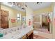 Bathroom with a tiled sink, a walk-in shower with glass doors, and peach-colored towels at 8210 E Del Cadena Dr, Scottsdale, AZ 85258