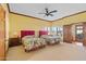 Spacious bedroom with two queen beds, a ceiling fan, and windows with plantation shutters at 8210 E Del Cadena Dr, Scottsdale, AZ 85258