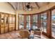 Cozy breakfast nook with tile flooring, wooden trim, and a view of the outdoor patio and pool at 8210 E Del Cadena Dr, Scottsdale, AZ 85258