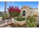 Inviting front yard with decorative fountain and colorful flowerbeds at 8210 E Del Cadena Dr, Scottsdale, AZ 85258
