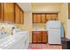 Functional laundry room with washer, dryer, sink, cabinetry, and tiled flooring at 8210 E Del Cadena Dr, Scottsdale, AZ 85258