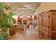 Spacious living room with exposed-beam vaulted ceiling and terra cotta tile flooring at 8210 E Del Cadena Dr, Scottsdale, AZ 85258