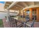 Covered outdoor dining area featuring a large table and grill, perfect for entertaining at 8210 E Del Cadena Dr, Scottsdale, AZ 85258