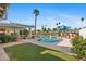 Private backyard pool with a manicured lawn, patio, and a lush tropical landscaping at 8210 E Del Cadena Dr, Scottsdale, AZ 85258