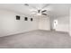 Large bedroom with carpet, a ceiling fan, and an open area leading to the second floor at 8879 W Cameron Dr, Peoria, AZ 85345