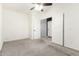 Bedroom with carpet, ceiling fan, and double doors leading to another room at 8879 W Cameron Dr, Peoria, AZ 85345
