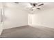 A bedroom with a ceiling fan, carpet flooring, and a window with blinds at 8879 W Cameron Dr, Peoria, AZ 85345