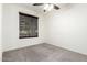 Carpeted bedroom featuring a window with blinds and a ceiling fan with lighting at 8879 W Cameron Dr, Peoria, AZ 85345