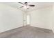 Bedroom with carpet, a ceiling fan, and an open door leading to another room at 8879 W Cameron Dr, Peoria, AZ 85345