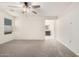 A very spacious bedroom with a ceiling fan and carpet flooring at 8879 W Cameron Dr, Peoria, AZ 85345