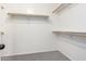 A walk-in closet with shelves and bars for clothing storage, and carpet flooring at 8879 W Cameron Dr, Peoria, AZ 85345