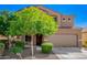 Inviting two-story home with a two-car garage, mature landscaping, and a welcoming front entryway at 8879 W Cameron Dr, Peoria, AZ 85345