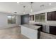 Bright kitchen with a center island, sleek countertops, stainless steel appliances, and modern pendant lighting at 8879 W Cameron Dr, Peoria, AZ 85345