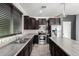 This kitchen features stainless steel appliances, dark cabinets, and tile backsplash at 8879 W Cameron Dr, Peoria, AZ 85345