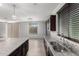 Modern kitchen with stainless steel appliances, dark cabinets, and a central island offering both style and functionality at 8879 W Cameron Dr, Peoria, AZ 85345