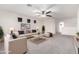 Bright and airy living room featuring a comfortable sofa, ceiling fan and a welcoming atmosphere at 8879 W Cameron Dr, Peoria, AZ 85345