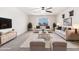 Cozy living room with neutral furniture, stylish decor, ceiling fan and bright natural light at 8879 W Cameron Dr, Peoria, AZ 85345