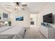 Bright Primary bedroom with neutral tones, a large bed, ceiling fan and an ensuite bathroom at 8879 W Cameron Dr, Peoria, AZ 85345