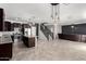 An open-concept space blends kitchen, dining, and living areas, enhanced by stylish lighting and sleek design at 8879 W Cameron Dr, Peoria, AZ 85345