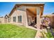 Beautiful backyard with artificial turf, covered patio, and a tranquil seating area at 8921 W Laurel Ln, Peoria, AZ 85345