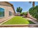 Expansive backyard with lush artificial grass, mature trees, and desert landscaping at 8921 W Laurel Ln, Peoria, AZ 85345