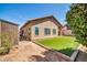 Well-maintained backyard featuring green artificial turf, shed and neutral color palette at 8921 W Laurel Ln, Peoria, AZ 85345