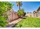 Private backyard with lush green turf, mature trees, and well-maintained landscaping at 8921 W Laurel Ln, Peoria, AZ 85345