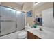 Bathroom features custom shower door, vanity, and serene atmosphere at 8921 W Laurel Ln, Peoria, AZ 85345
