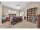 This bedroom offers a vaulted ceiling, natural light, and a custom bookshelf at 8921 W Laurel Ln, Peoria, AZ 85345