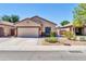 Inviting single-story home with well-maintained landscaping, attached garage, and a cozy bench near the entrance at 8921 W Laurel Ln, Peoria, AZ 85345