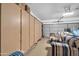 Spacious garage with ample storage cabinets and a separate seating area at 8921 W Laurel Ln, Peoria, AZ 85345