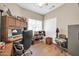 Functional office with built-in desk, comfortable seating, and overhead lighting at 8921 W Laurel Ln, Peoria, AZ 85345
