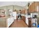 A kitchen area features wood cabinets, stainless-steel appliances, and a central island at 8921 W Laurel Ln, Peoria, AZ 85345