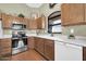 A kitchen features wood cabinets, stainless-steel appliances, and a white countertop at 8921 W Laurel Ln, Peoria, AZ 85345
