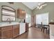 A kitchen features wood cabinets, white countertops, and a stainless-steel faucet at 8921 W Laurel Ln, Peoria, AZ 85345